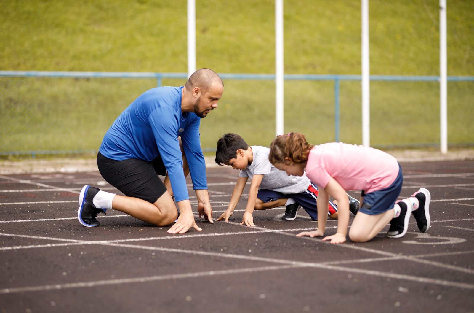 Youth track and field athletes practicing sprint drills with proper warm‑up and technique.