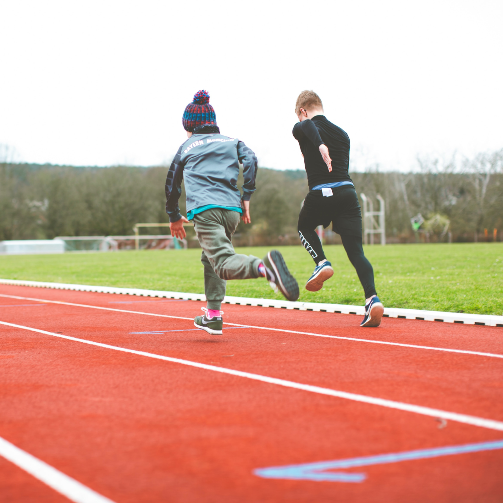 Youth athletes performing speed and agility drills, including sprint starts and ladder footwork exercises, during training at 12th Rock.