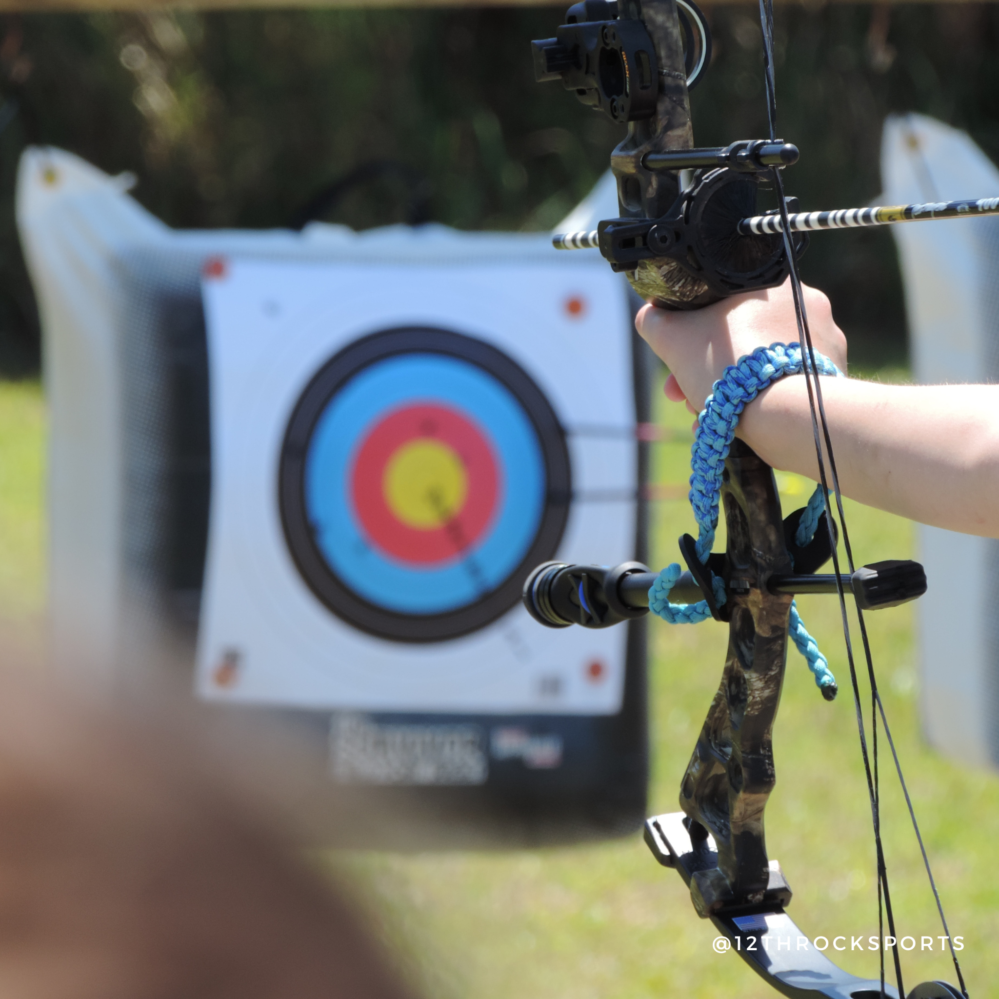 Young athletes practicing archery skills during a 12th Rock training session
